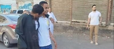 طالب يساند صديقه على عكاز أثناء دخوله لجنة الثانوية العامة بقنا